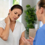 Patient discussing neck pain and headaches with a wellness provider in Glenelg MD