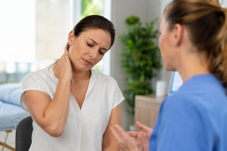 Patient discussing neck pain and headaches with a wellness provider in Glenelg MD
