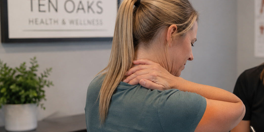 Patient discussing recurring muscle tightness with a wellness provider in Glenelg MD