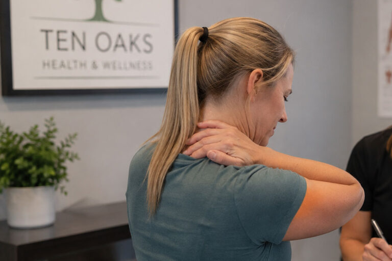 Patient discussing recurring muscle tightness with a wellness provider in Glenelg MD